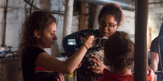 Meghan Ciafre and Analisa Johnson prep a camera on the set of "Seventeen" (FA18 • ART467)