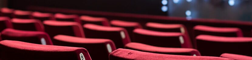 Empty theater with red chairs. Rear view.